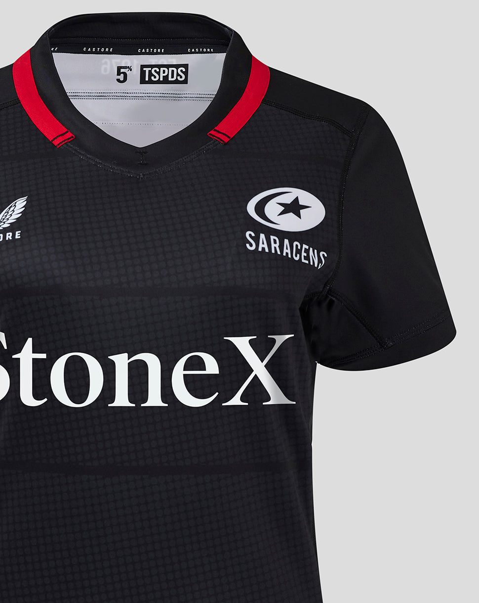 Close up of Saracens women's 24/25 home shirt in black with red collar trim and StoneX sponsor logo