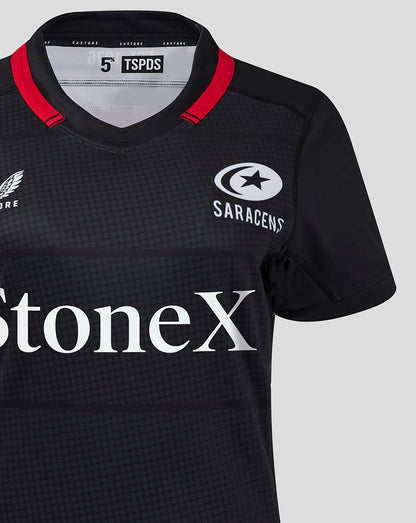 Close up of Saracens women's 24/25 home shirt in black with red collar trim and StoneX sponsor logo