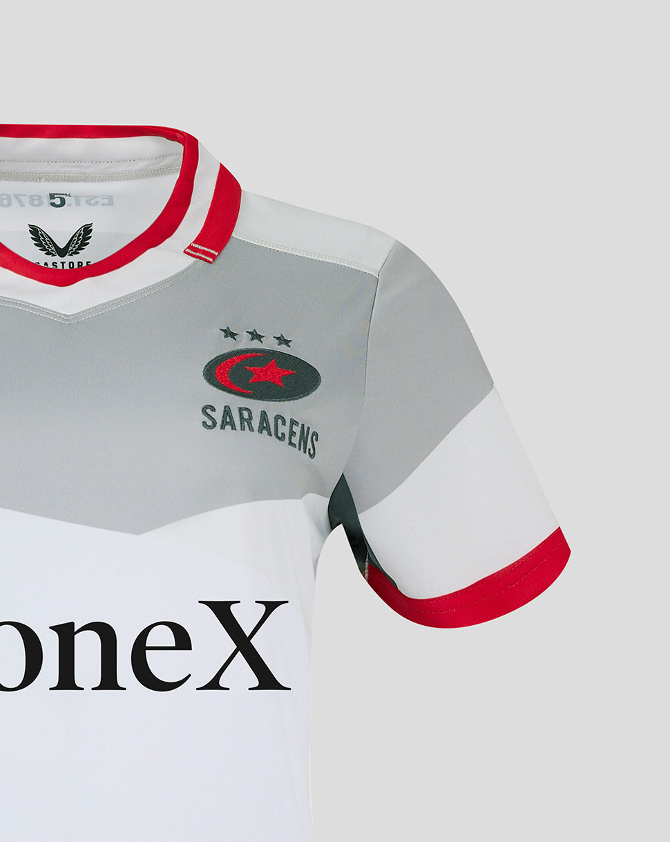 Close-up of Saracens crest on chest of away shirt showing grey panels and red collar details