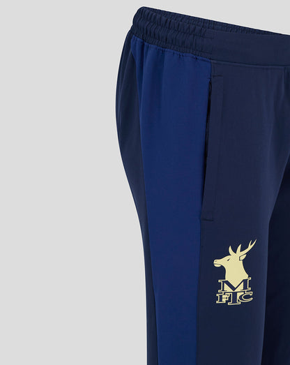 Close-up of the lower leg showing the gold deer emblem on navy Mansfield training pants.