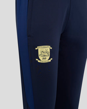 Close-up of navy training pants thigh with gold Preston North End crest.
