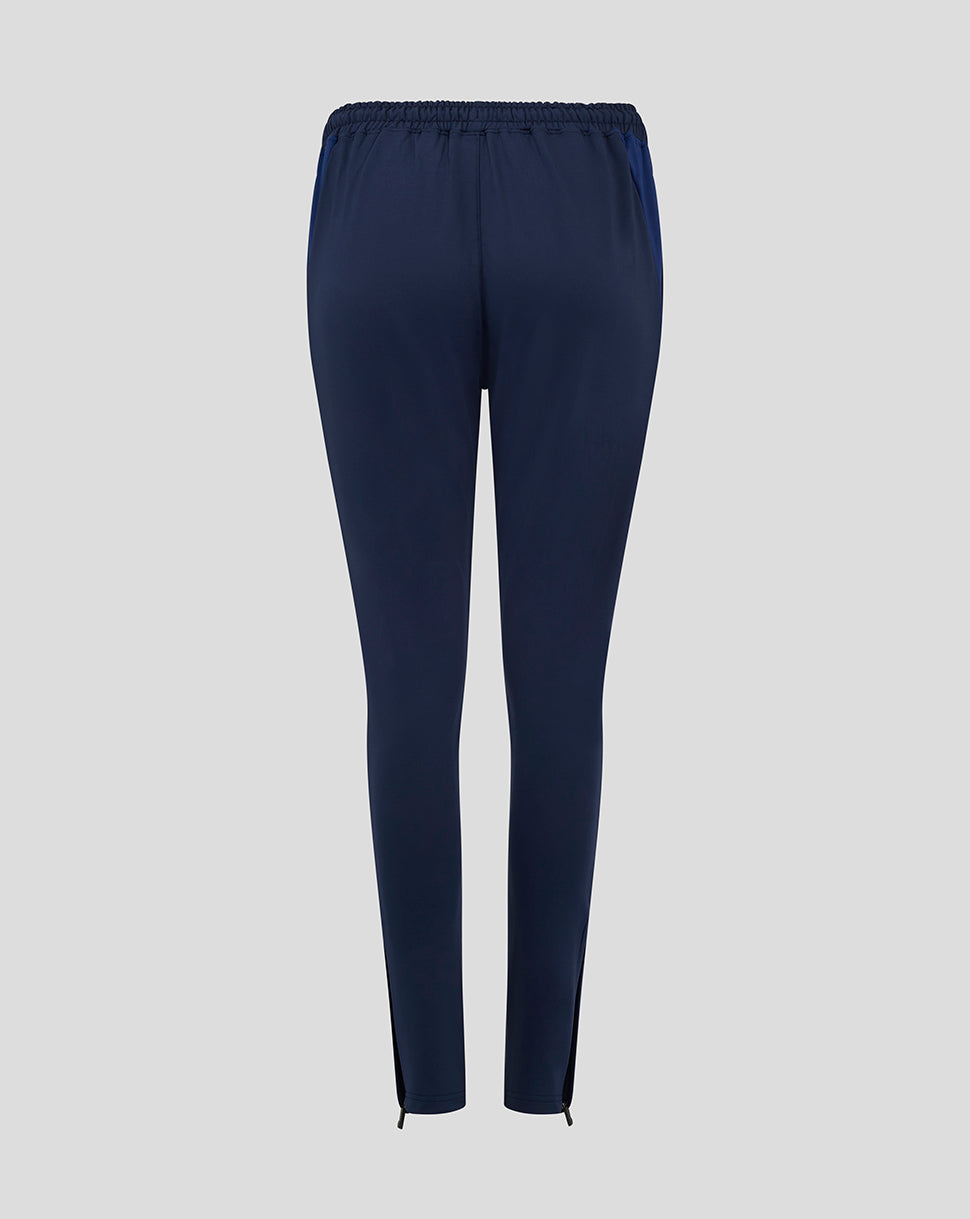 Back view of navy Preston NE training pants with zipped ankles, crest on left thigh and Castore logo on right thigh
