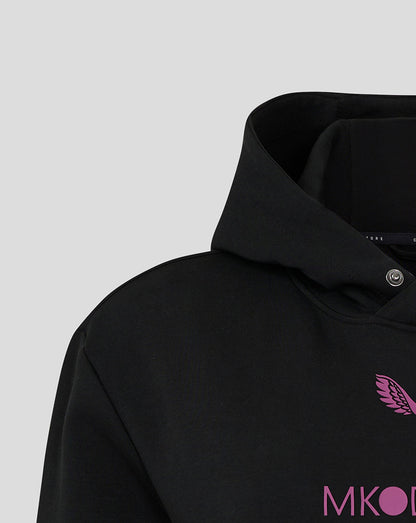 Close-up of black Mk Dons women's travel logo hoody with a pink wing emblem on the chest