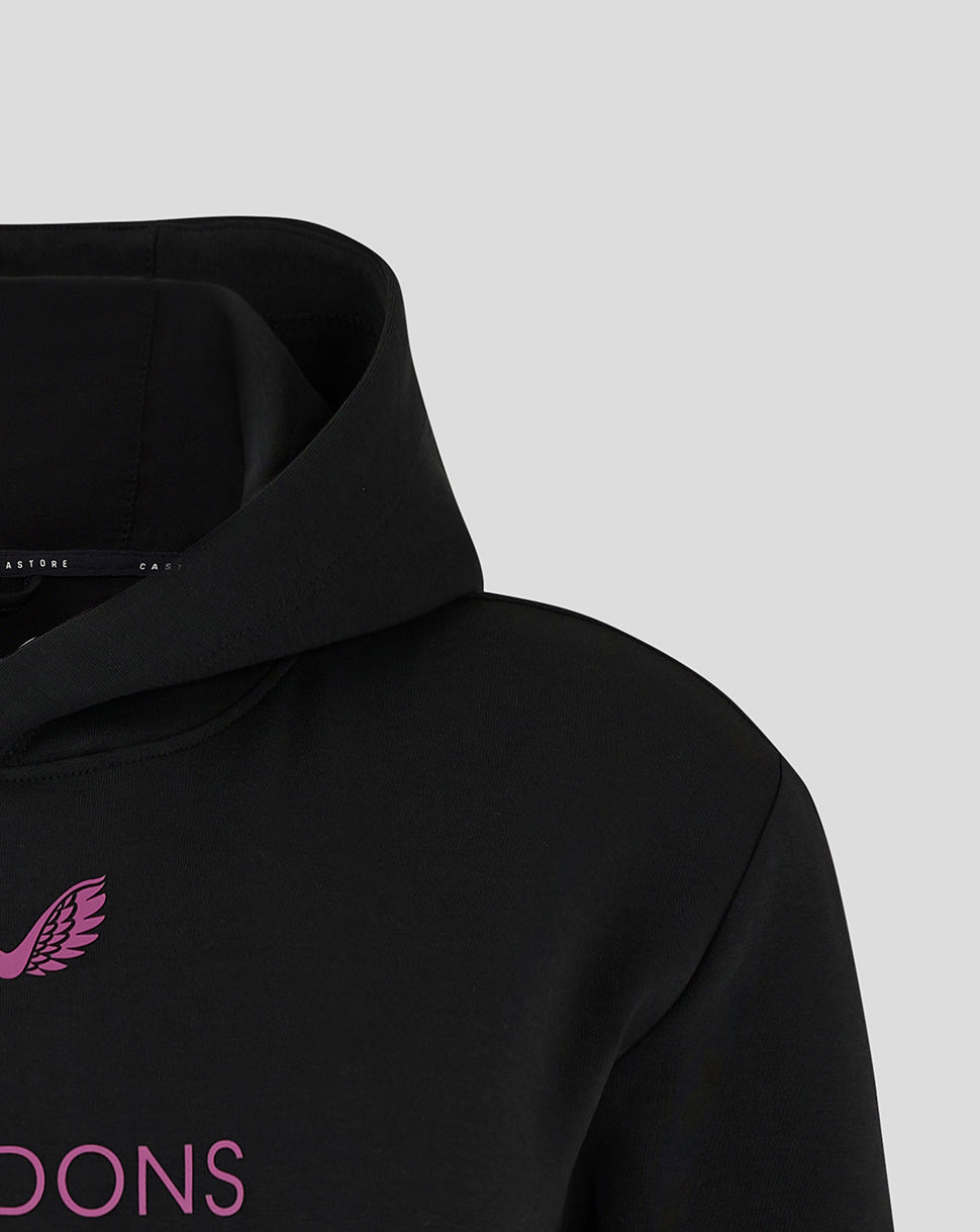 Close-up of black Mk Dons travel hoodie collar with pink logo on the chest