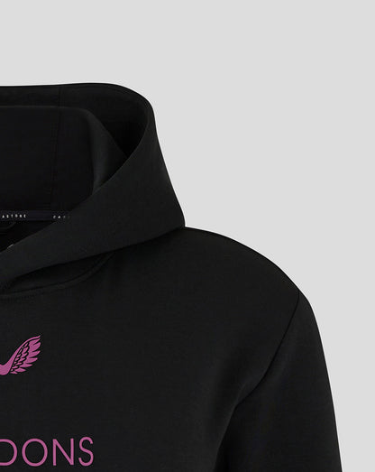 Close-up of black Mk Dons travel hoodie collar with pink logo on the chest