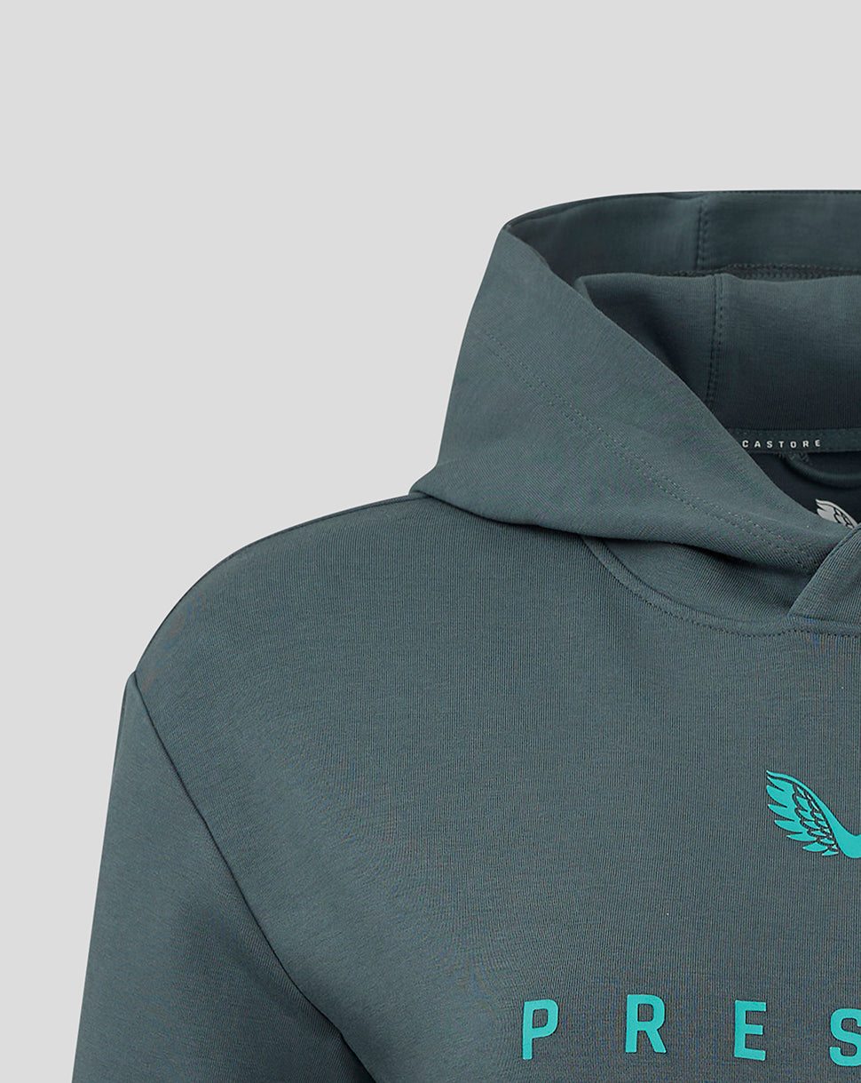 Close-up of Preston NE travel logo hoody chest on teal fabric with turquoise crest and partial Preston text.