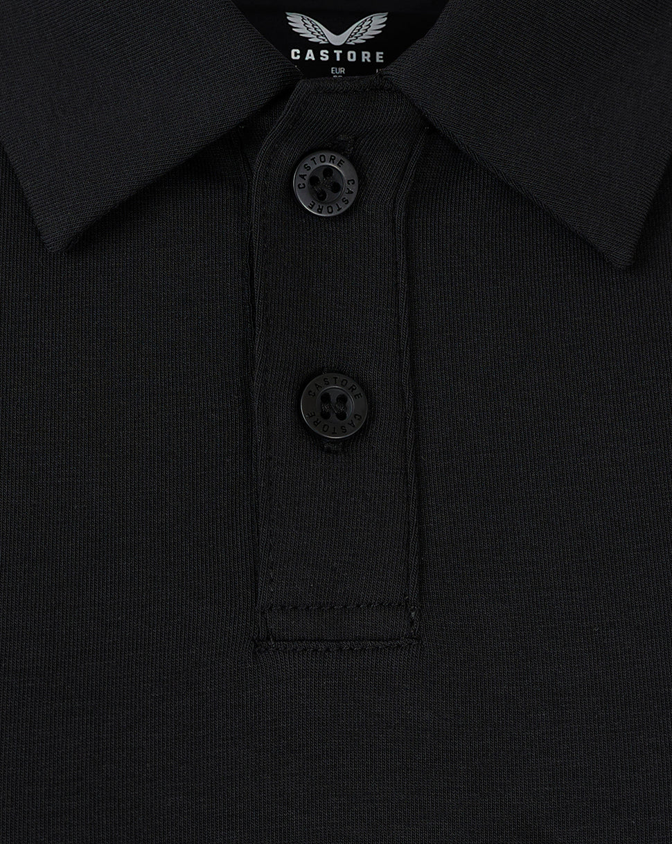 Close-up of black polo collar with button placket and Castore label at the neckline