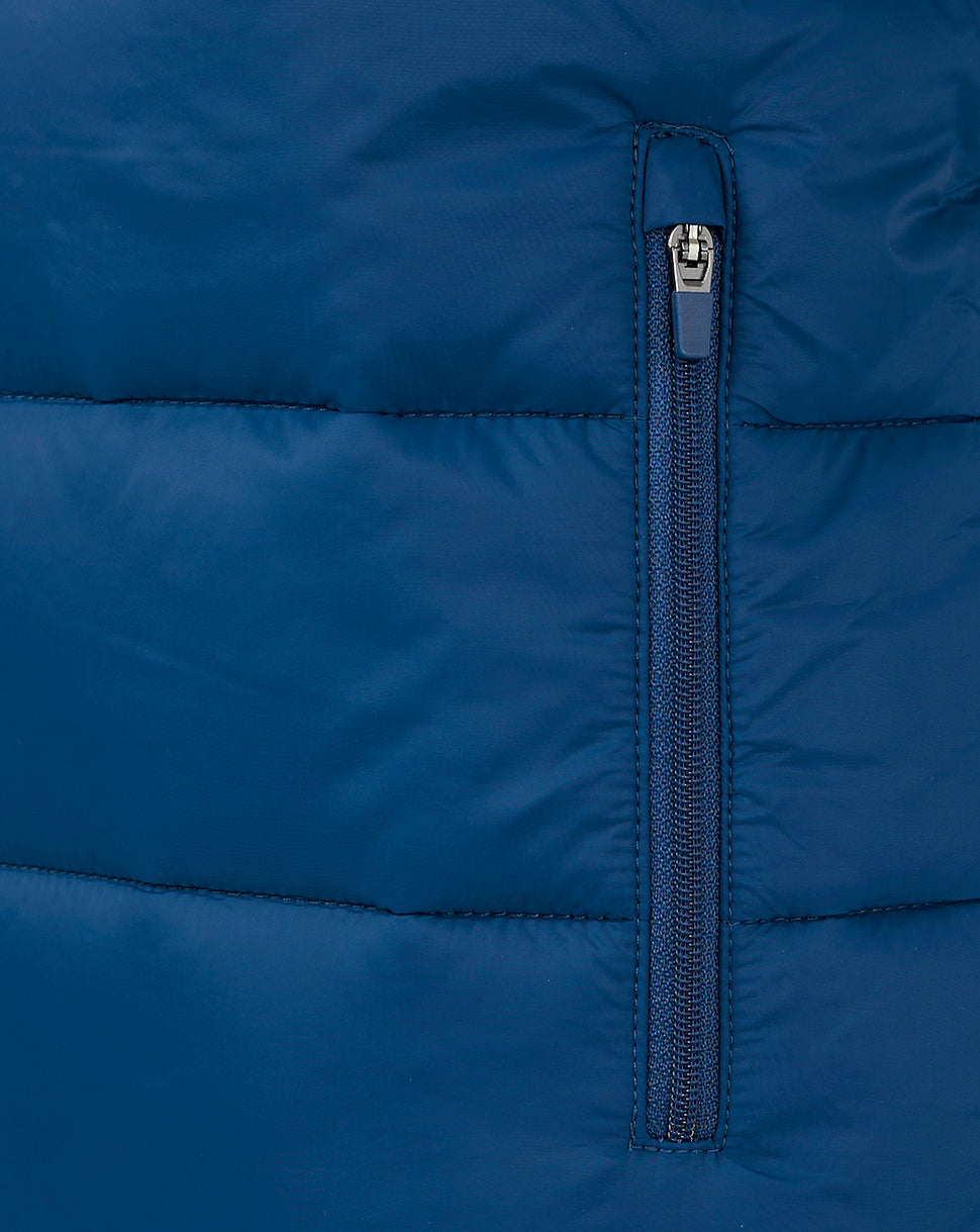Close up of navy padded gilet zipper detail with vertical zip and stitched panels.