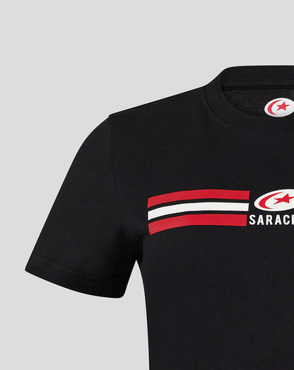 Left side of black Saracens tee showing circular emblem and bold red stripe design.