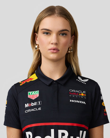 Close up of a model wearing the night sky navy Red Bull Racing polo highlighting chest logos and collar details