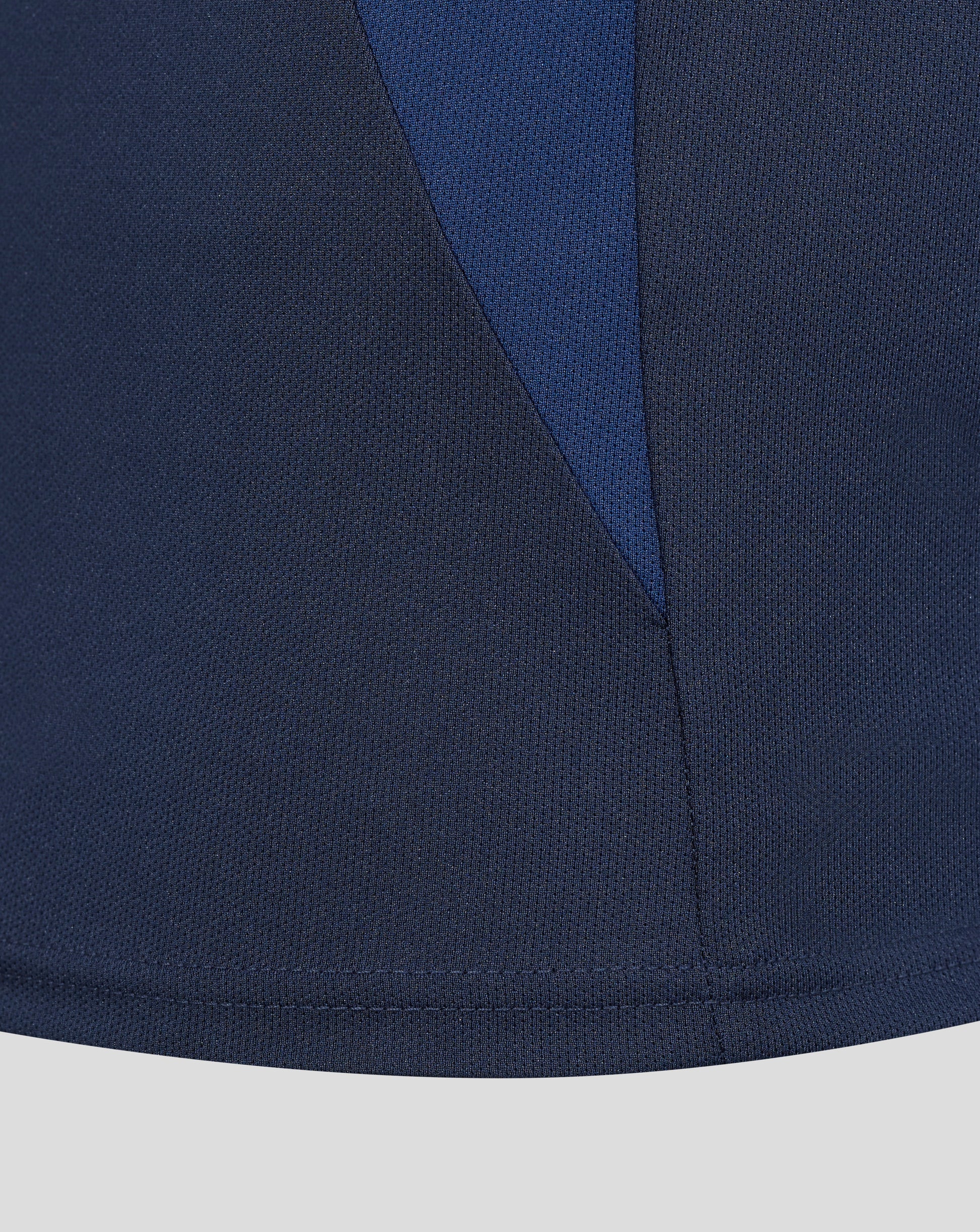 Close up of navy blue fabric with a diagonal seam from the Sydney Roosters 2025 women's pro players presentation polo