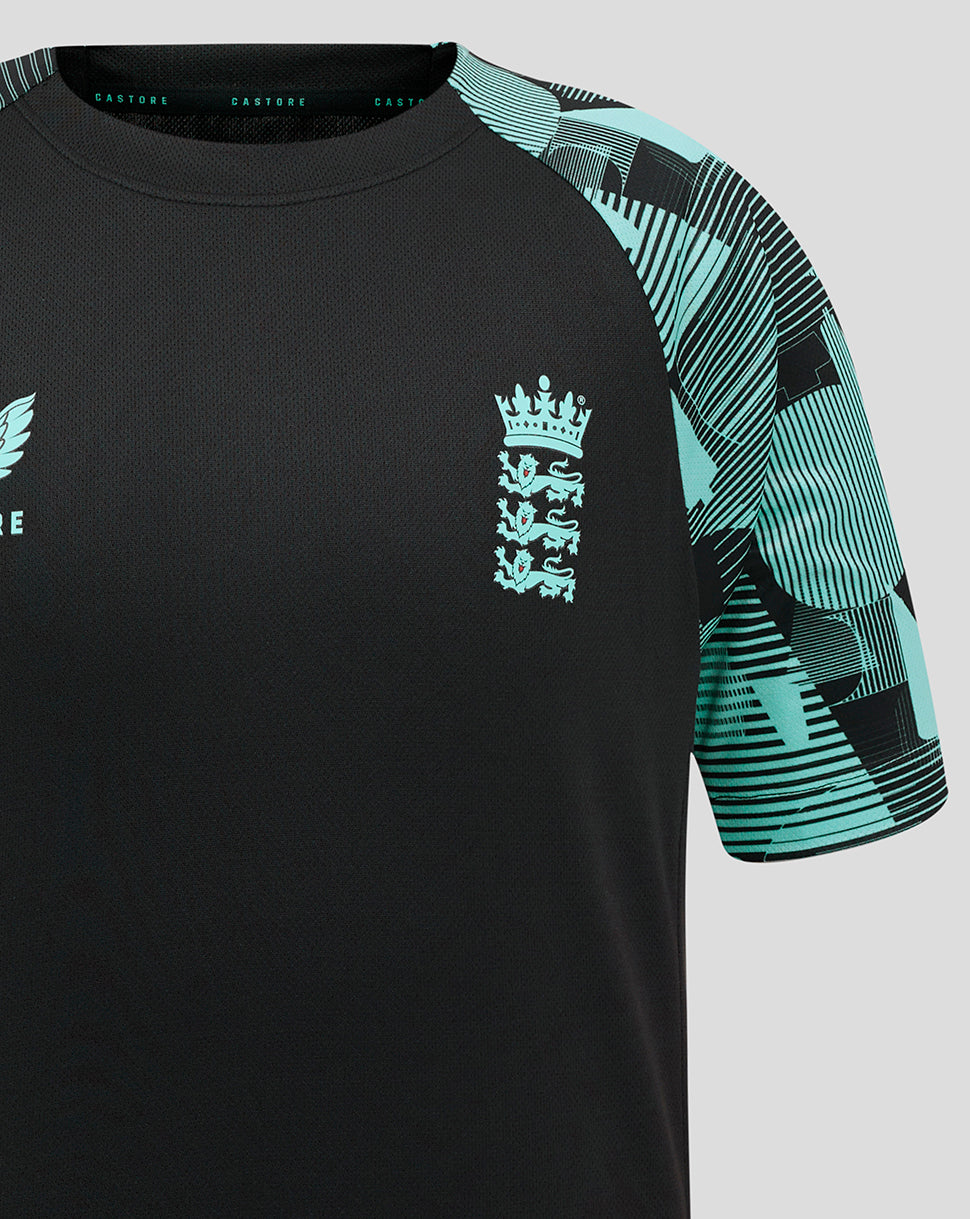 Upper chest detail of the junior Ashes tee showing England crest on black fabric and teal patterned sleeve.