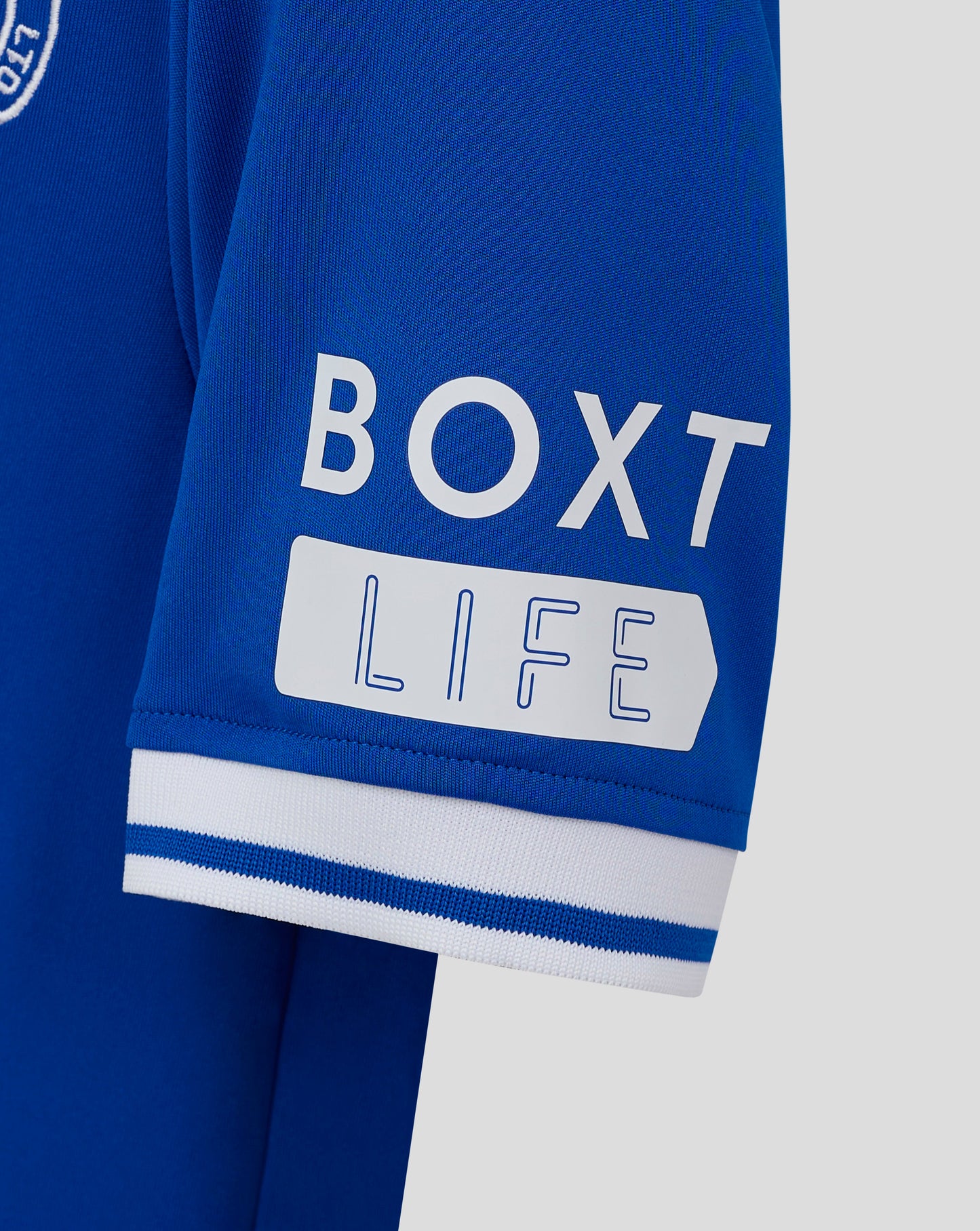 Close up of blue Rangers junior jersey sleeve showing knit texture and white striped cuff