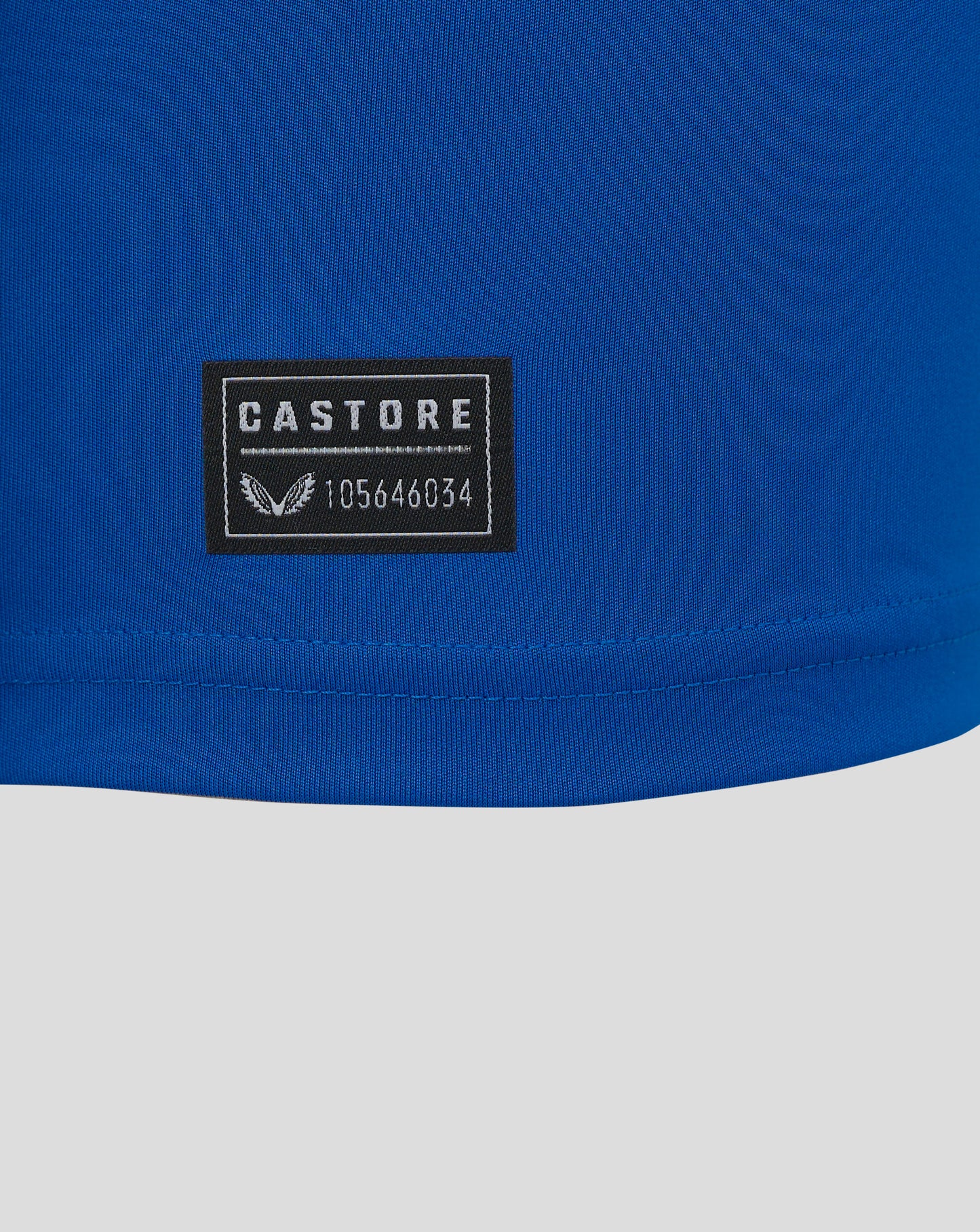 Castore label patch on blue fabric with Castore logo and product code 105646034