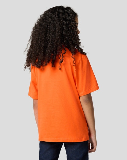 Back view of a young child wearing an oversized Exotic Orange Oracle Red Bull Racing Max Verstappen puzzle T-shirt