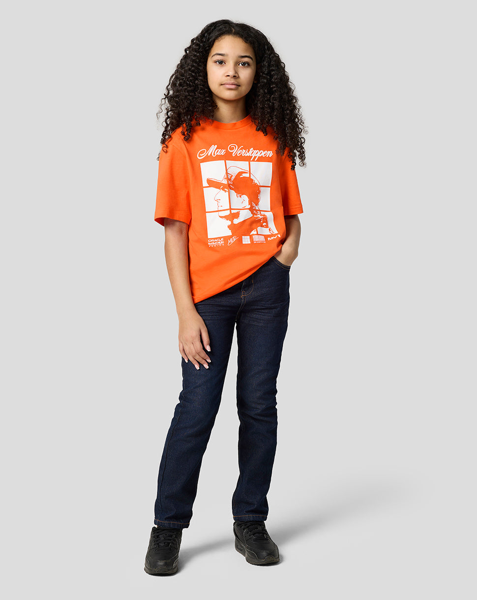Full body shot of a child in an Exotic Orange Max Verstappen puzzle T-shirt paired with blue jeans and white sneakers