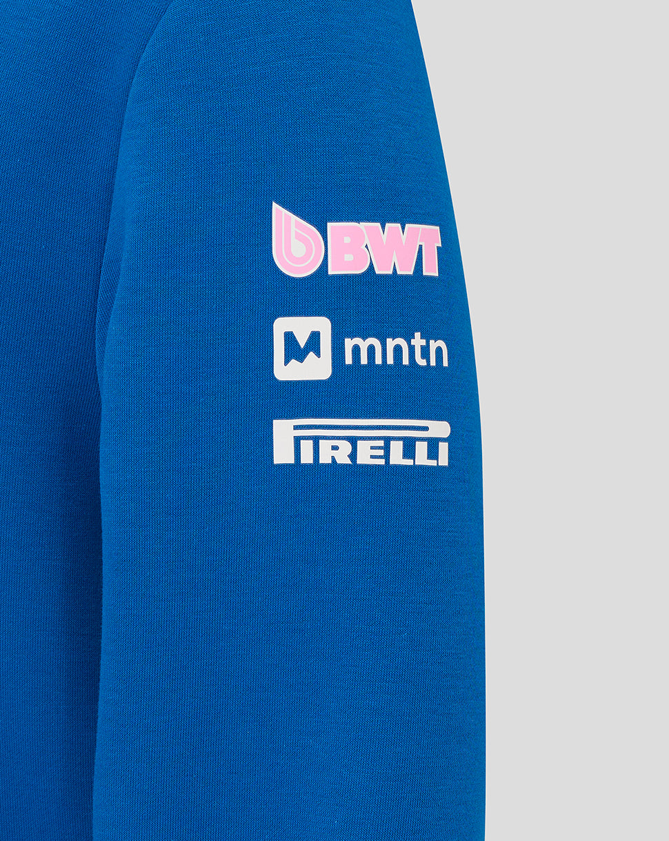 Close-up of the hoodie sleeve showing BWT MTN and Pirelli sponsor logos on lapis blue fabric.