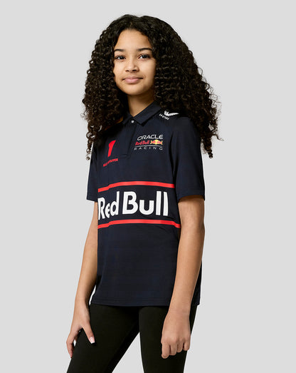 Girl wearing navy Red Bull Racing polo with Verstappen number 1 and large Red Bull branding