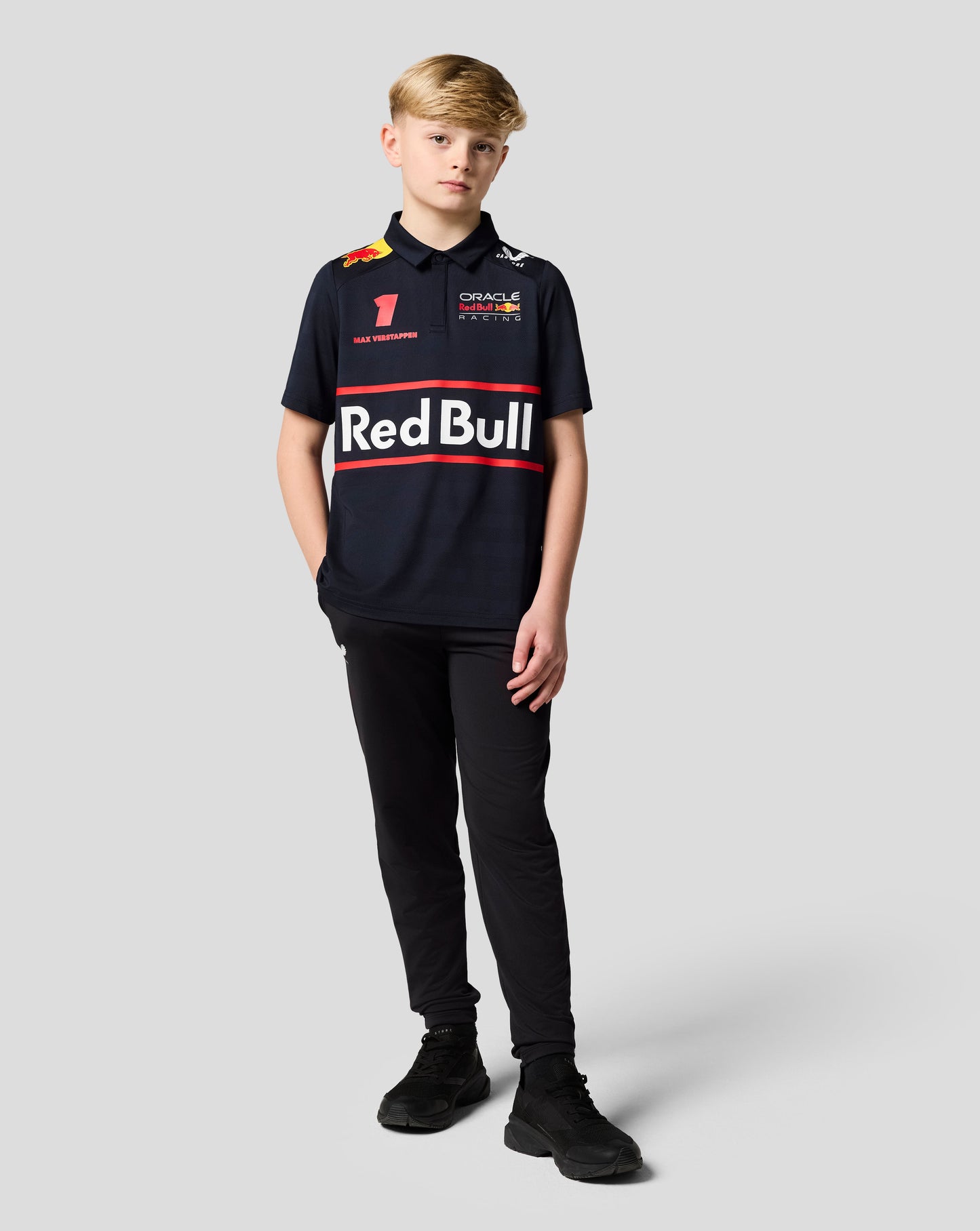 Young boy in a Night Sky Oracle Red Bull Racing junior polo with Verstappen graphics on the chest