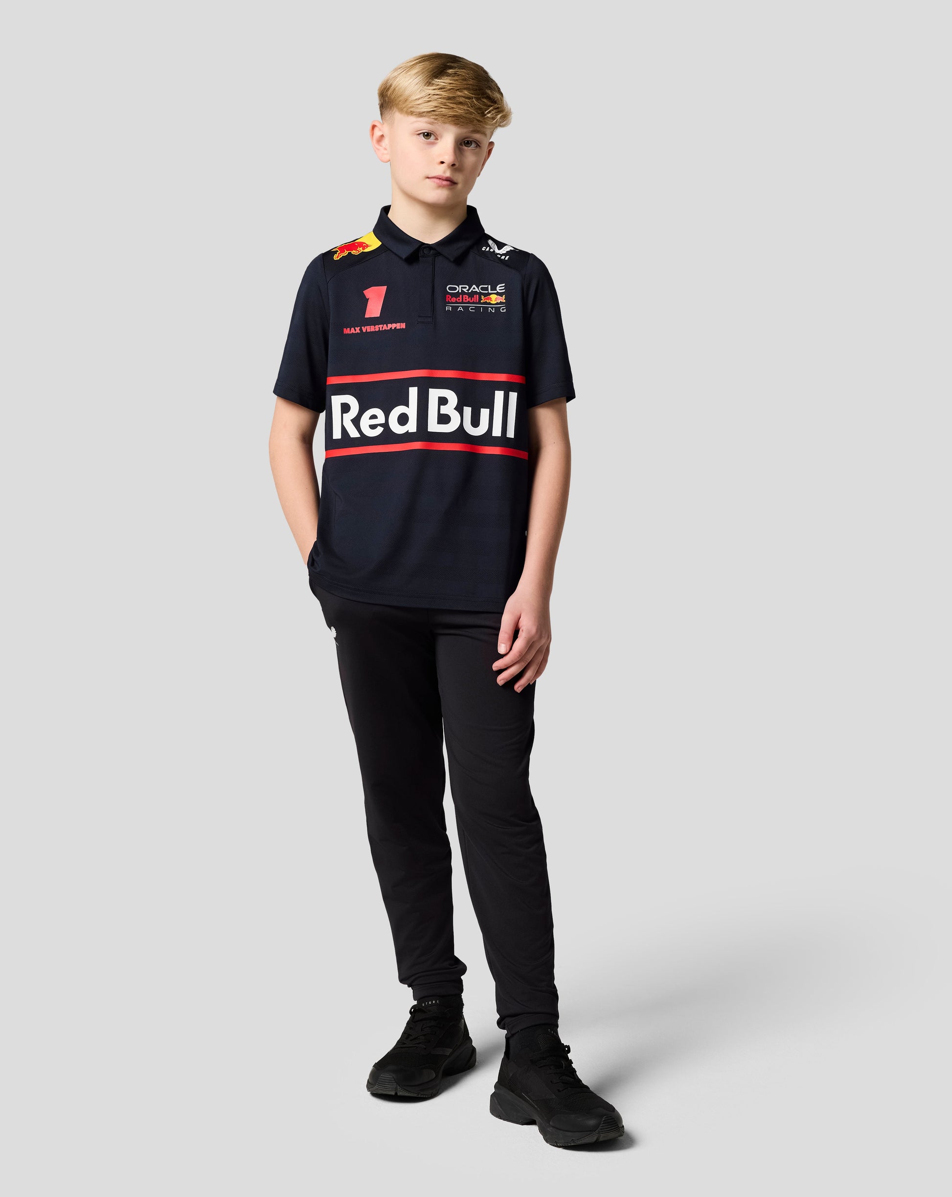 Young boy in a Night Sky Oracle Red Bull Racing junior polo with Verstappen graphics on the chest