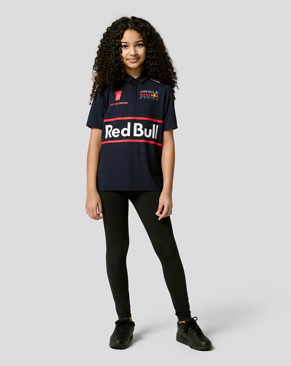 Young girl in a Night Sky Oracle Red Bull Racing junior polo showcasing large Red Bull branding across the chest