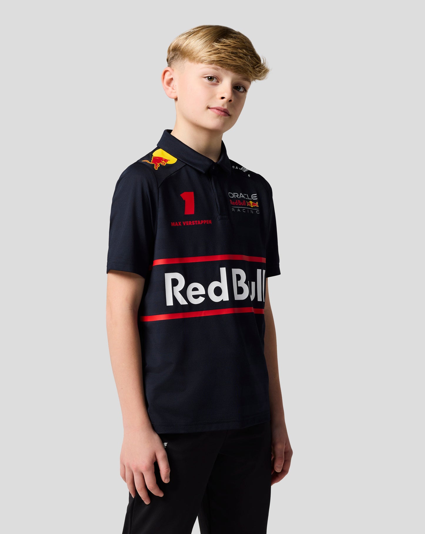 Boy in navy Red Bull Racing polo with Verstappen number 1 and prominent team graphics