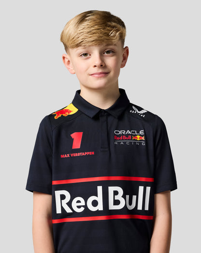 Front view of a child wearing a night sky navy Red Bull Racing polo with a bold Red Bull graphic and Max Verstappen branding across the chest