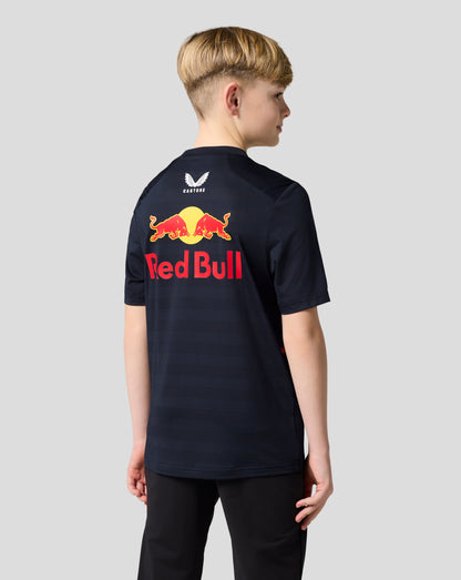 Back view of a child with short hair wearing a navy Red Bull Racing T shirt showing a large Red Bull logo and Castore branding on the back