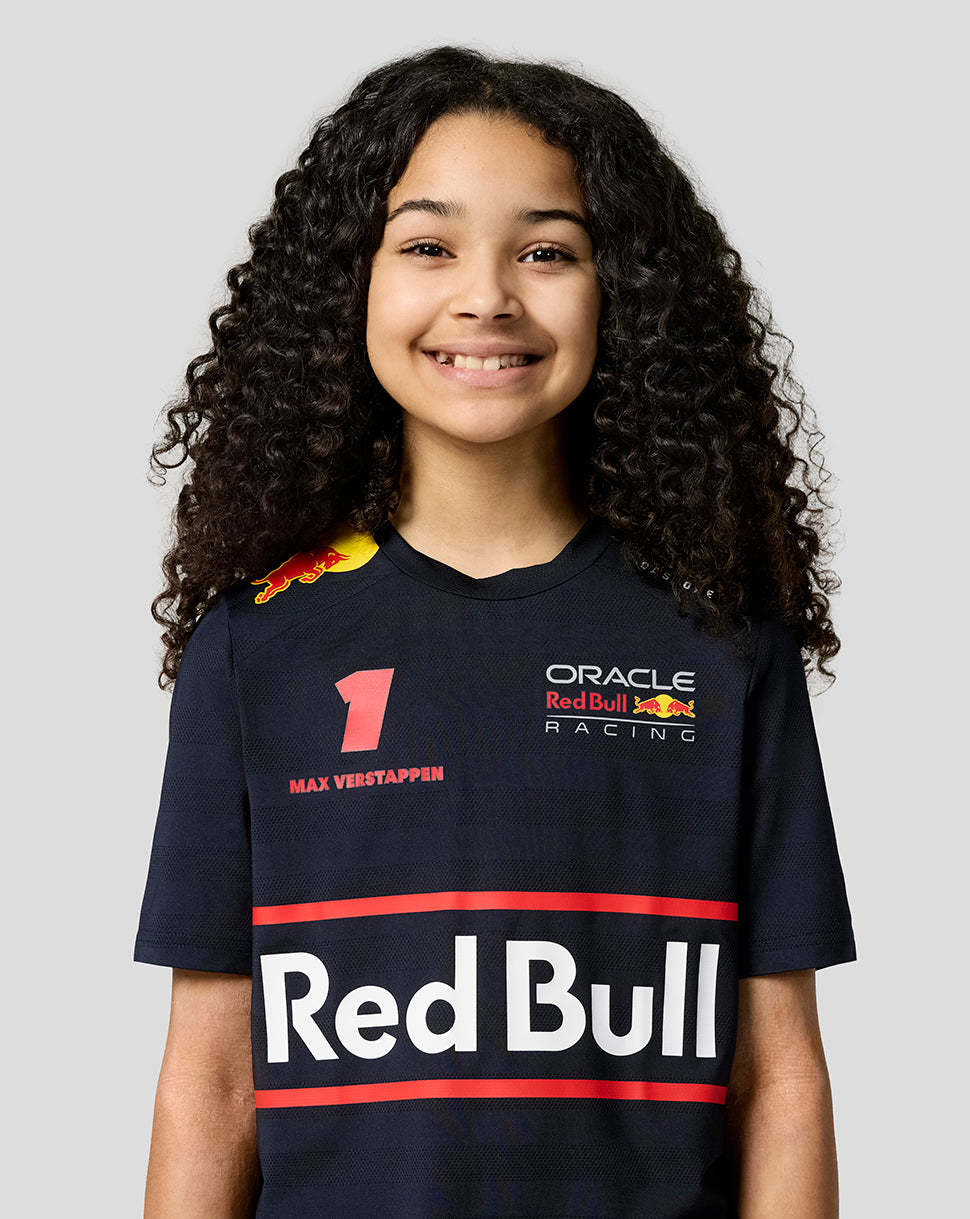 Close up of a girl in navy night sky Red Bull Racing Teamline shirt showing Verstappen artwork across the chest.