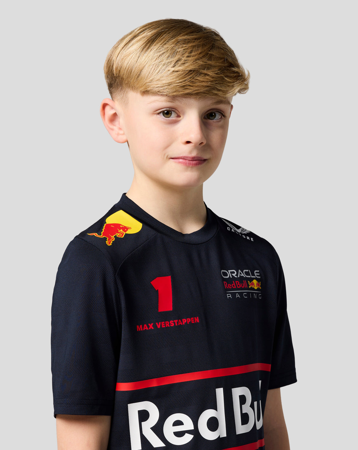 Smiling girl wearing a navy Red Bull Racing T shirt with Max Verstappen graphics and team branding