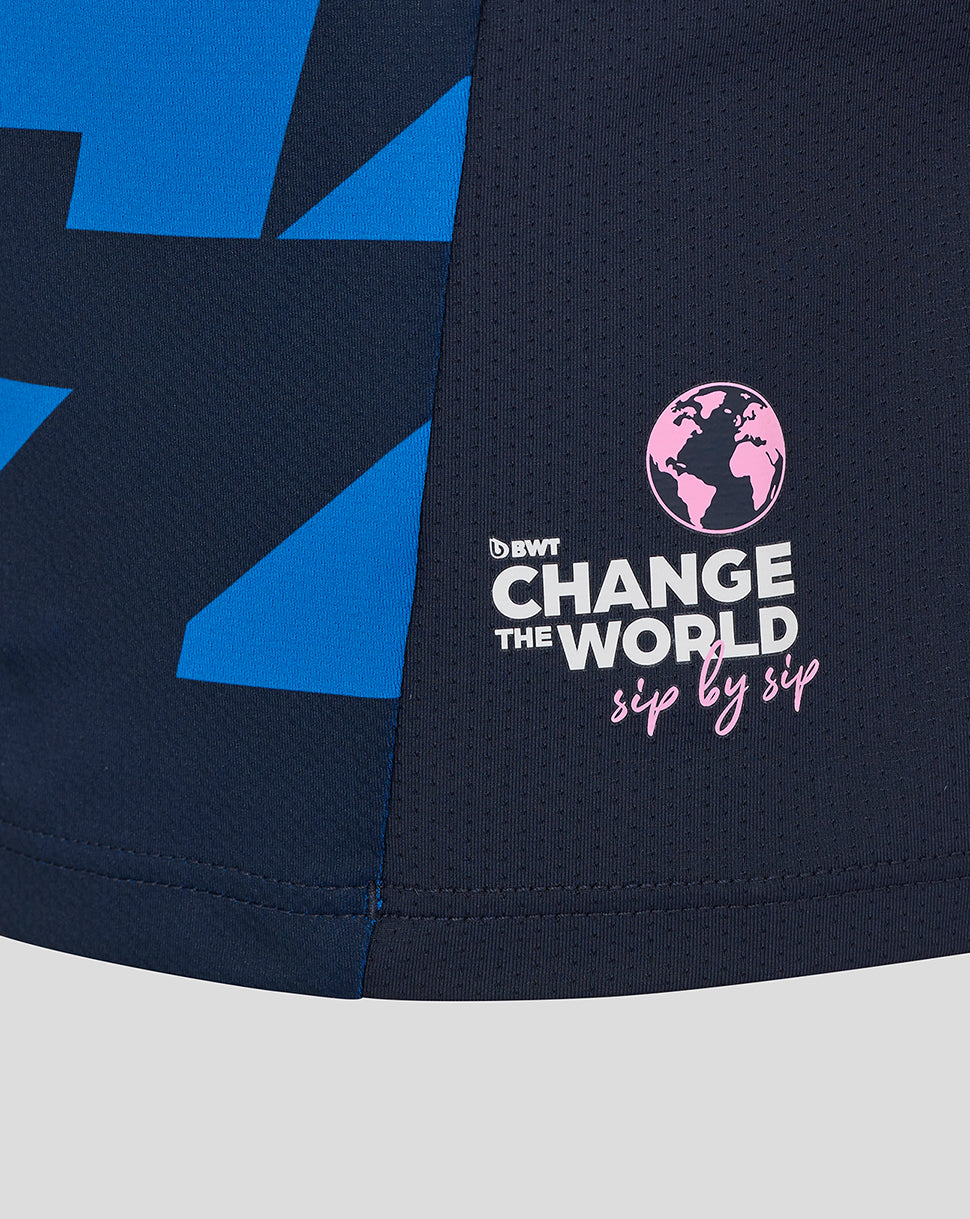 Navy Alpine junior driver jersey featuring blue geometric panels and a pink Change the World globe graphic