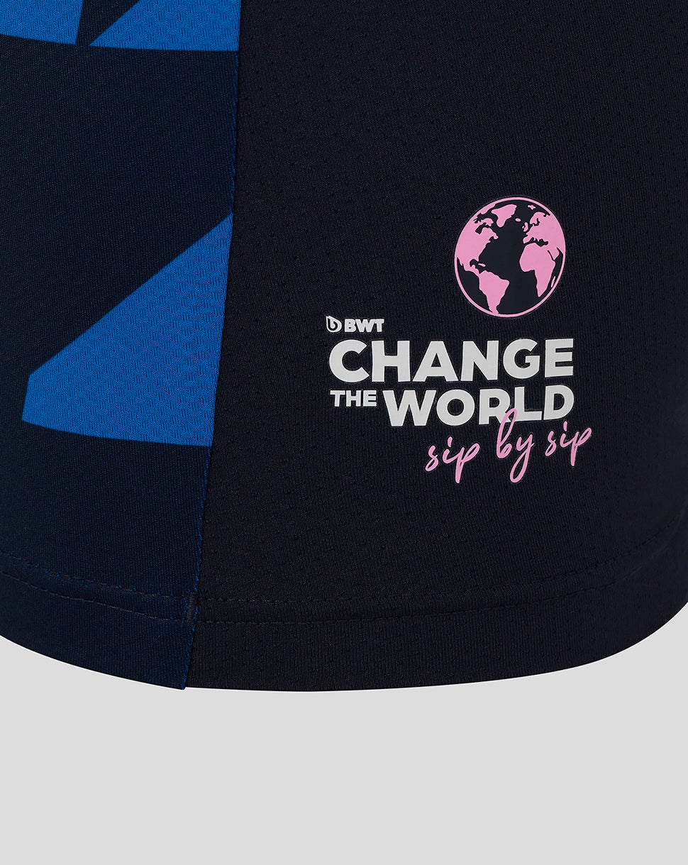 Close-up of navy fabric showing pink globe logo and Change the World sip by sip graphic