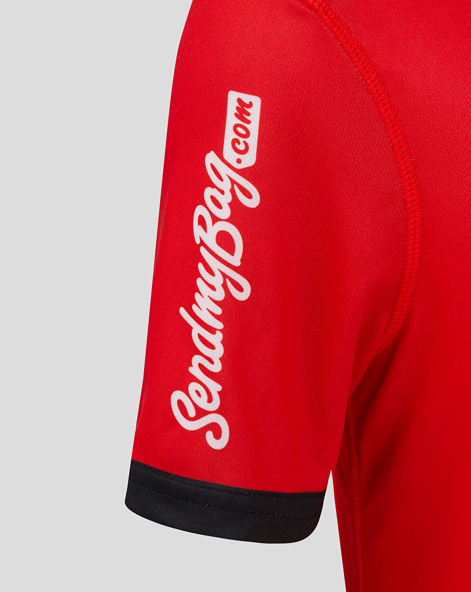Close-up of red sleeve showing white script branding on the Ulster away rugby shirt