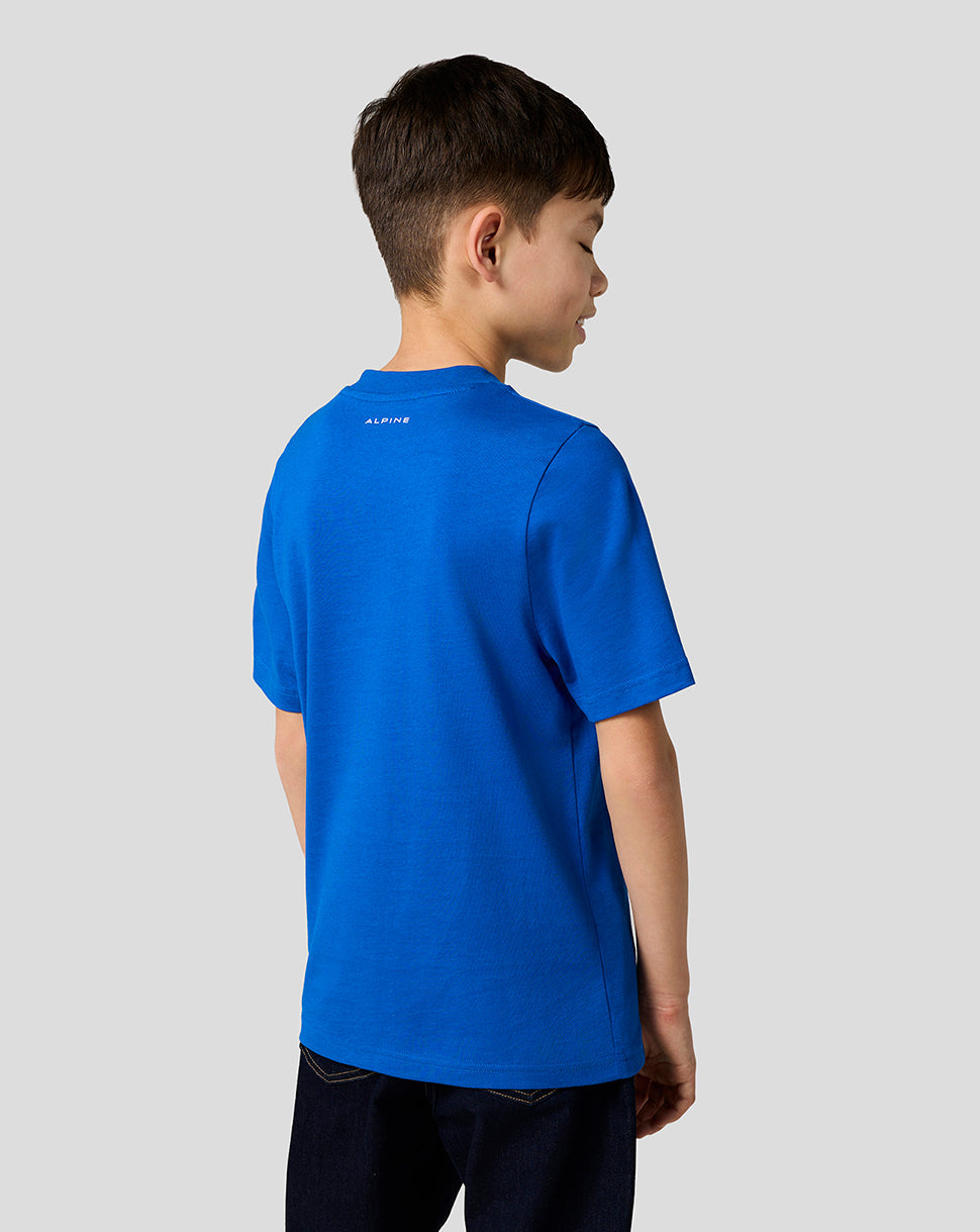 Back view of a young boy in lapis blue Alpine Core Essentials T shirt with a small Alpine logo at the neckline