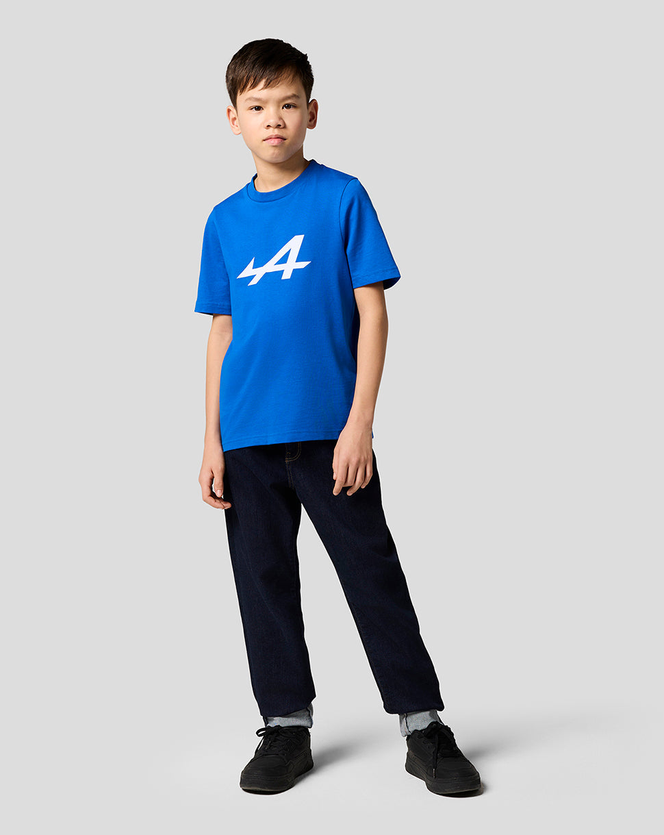 Boy wearing Alpine Juniors Core Essentials T-Shirt in lapis blue with a white Alpine logo on the chest.