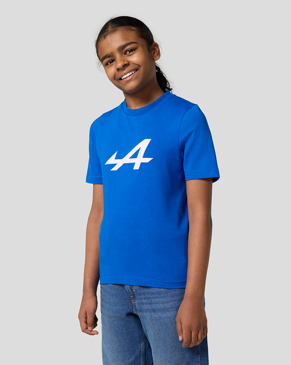 Young girl in lapis blue Alpine Juniors Core Essentials T shirt with a bold white Alpine logo on the front.