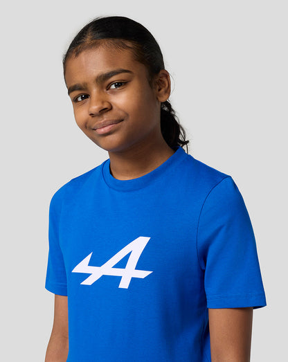 Girl wearing Alpine Juniors Core Essentials T-Shirt in lapis blue with a white Alpine logo on the front.