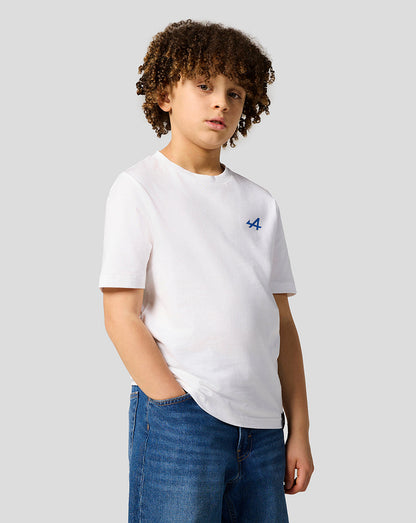 Child model wearing Alpine Juniors Graphic T-Shirt in white with small blue logo on the left chest.