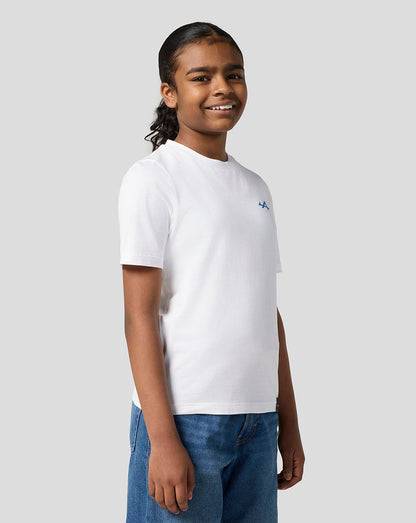 Child wearing Alpine Juniors white graphic T shirt with small blue logo on the left chest.