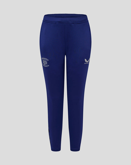 Blue Preston junior training pants with pockets, crest on left thigh and Castore logo on right thigh.