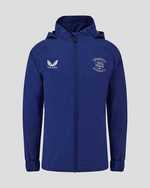 Front view of blue Preston North End junior training packable hood shower jacket with club crest and Castore logo