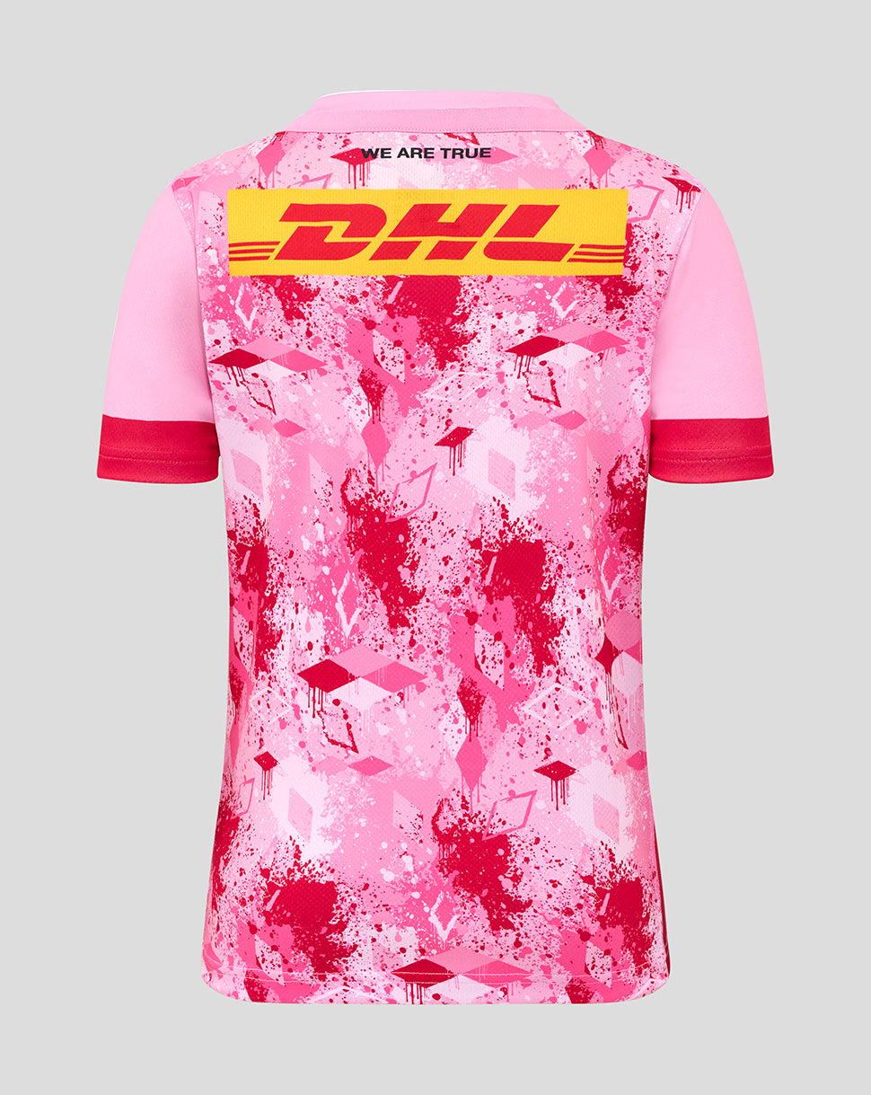 Back view of pink Harlequins junior away shirt with large DHL logo across the back and splatter print.