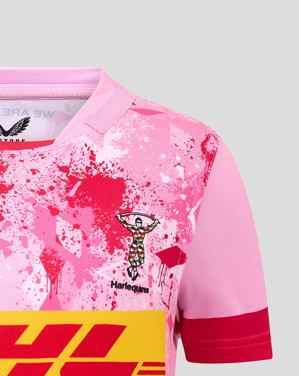 Close up of pink Harlequins junior away shirt showing the club crest and splatter print.