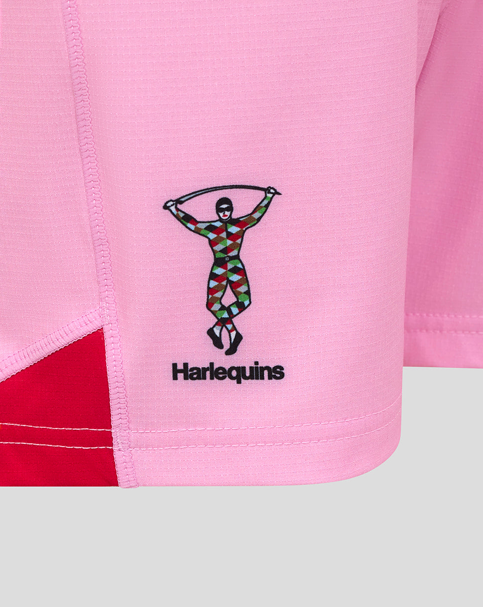 Close-up of pink fabric on Harlequins junior away replica shorts with the Harlequins crest on the lower left panel.