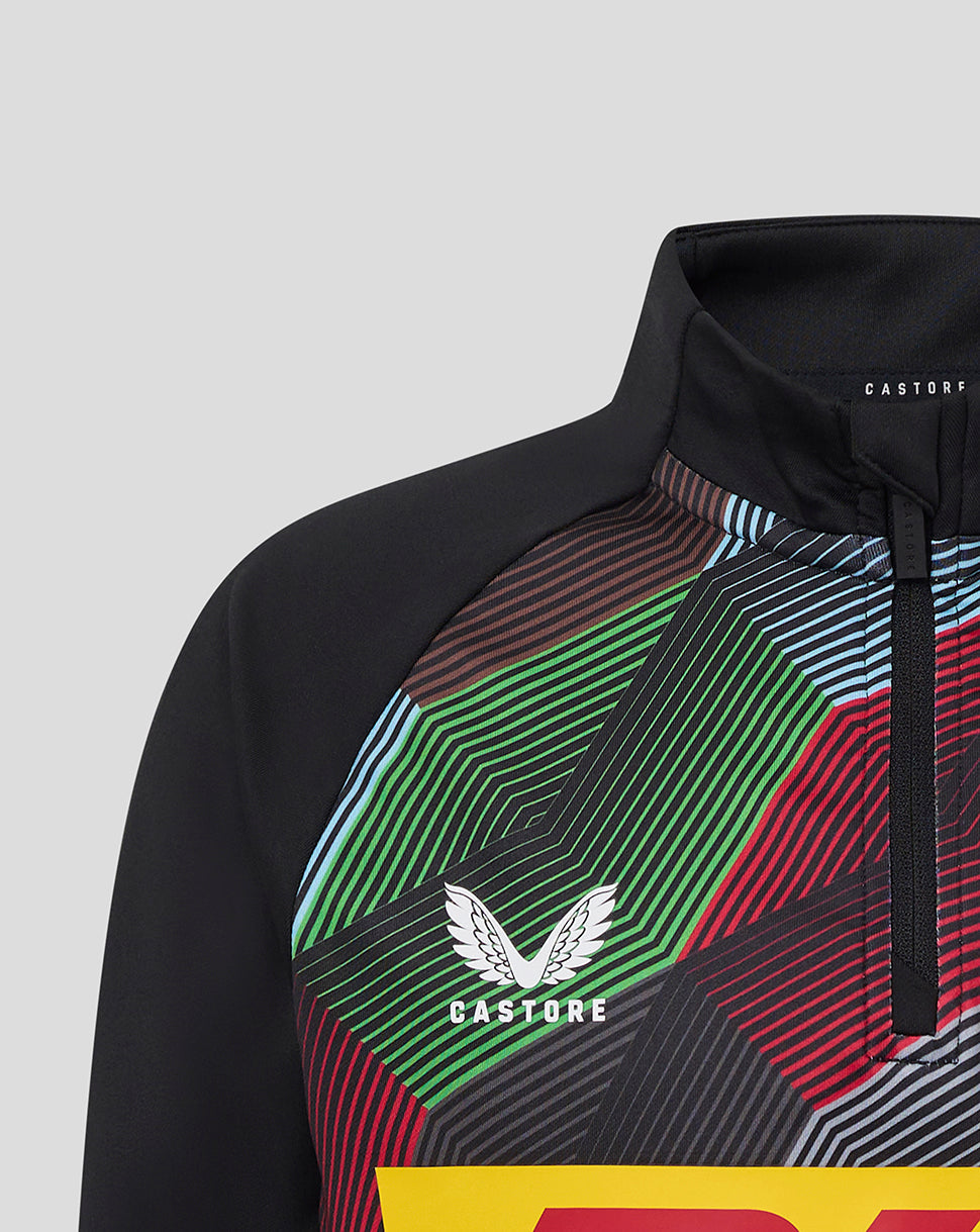 Close up of Harlequins junior quarter zip midlayer top with a bold multicolored geometric pattern and crest