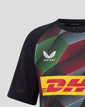 Close up of Harlequins matchday tee showing geometric print, DHL logo band and Castore branding.