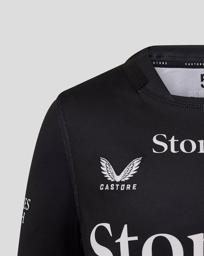 Front view close-up of black Saracens Junior 25/26 Replica Home Shirt showing crest and Castore branding.