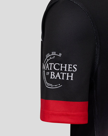 Close-up of black sleeve with red cuff and Watches of Bath logo on Saracens junior shirt
