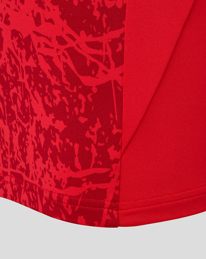 Close-up of the red abstract print on the front panel of the Saracens midlayer top