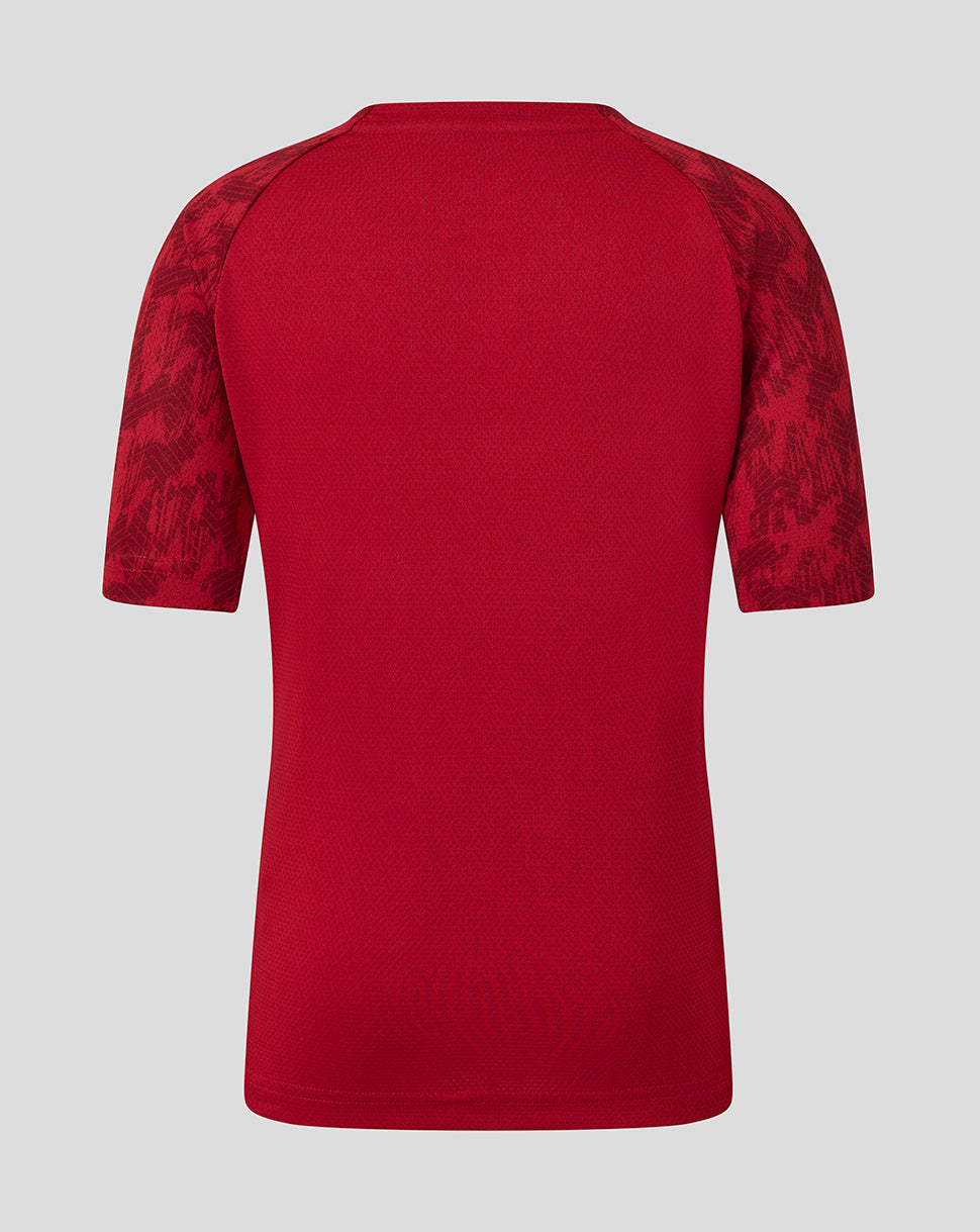Back view of red Saracens junior training short sleeve tee with patterned sleeves.
